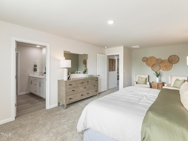 bedroom featuring recessed lighting, visible vents, ensuite bathroom, light carpet, and baseboards