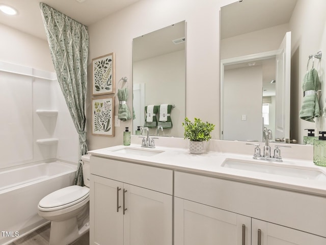 full bath featuring shower / bathtub combination, double vanity, visible vents, toilet, and a sink