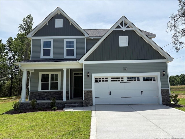 22 Peach Orchard Ln, Lillington, NC 27546 - craftsman-style house featuring a porch, stone siding, concrete driveway, a front lawn, and a garage