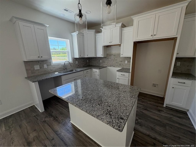 22 Peach Orchard Ln, Lillington, NC 27546 - kitchen featuring a sink, decorative backsplash, dark wood finished floors, and white cabinetry