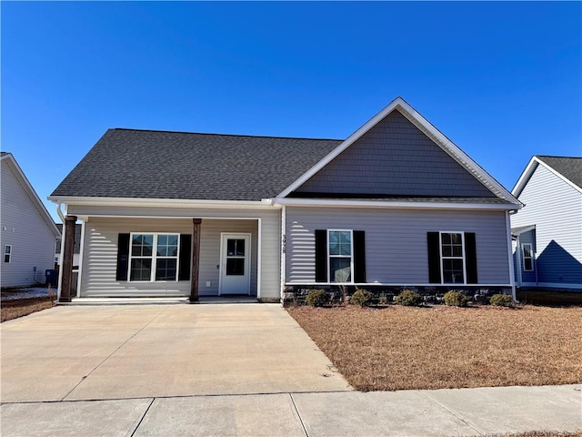 craftsman inspired home featuring a porch and roof with shingles