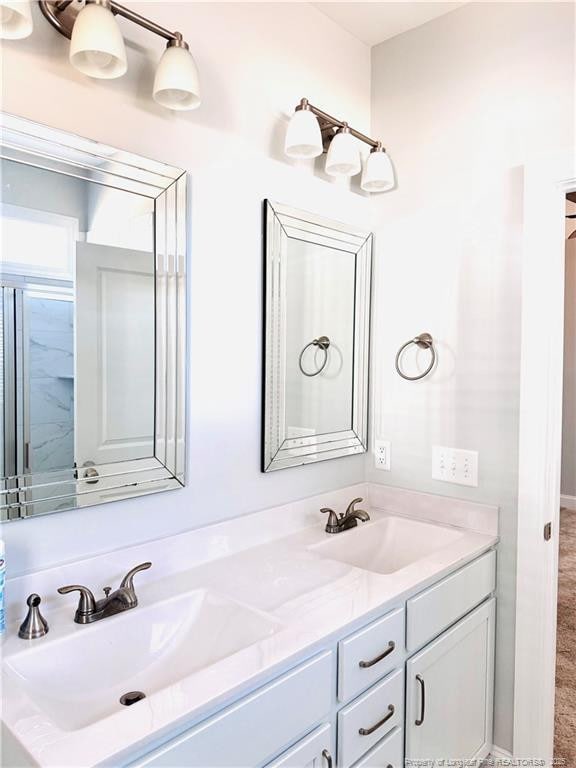 full bath with double vanity and a sink