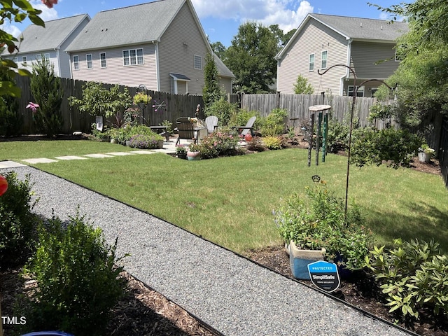 view of yard featuring a garden and a fenced backyard