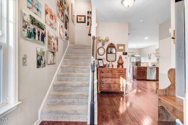 stairs with baseboards and hardwood / wood-style floors