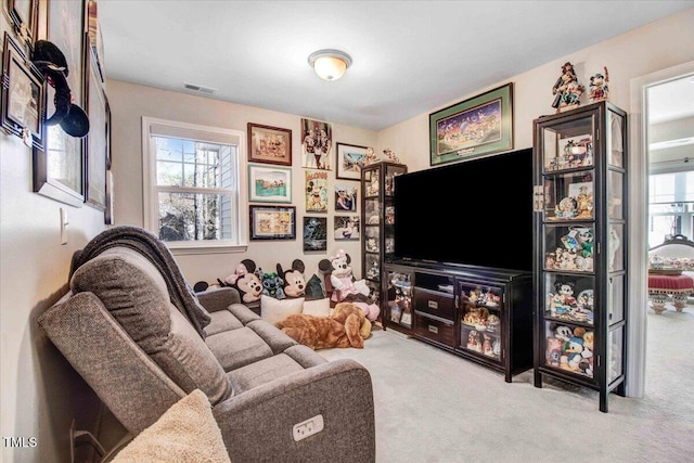 living area featuring carpet floors and visible vents