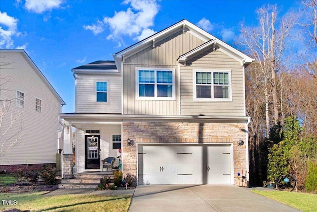 craftsman-style home with board and batten siding, concrete driveway, stone siding, and a garage