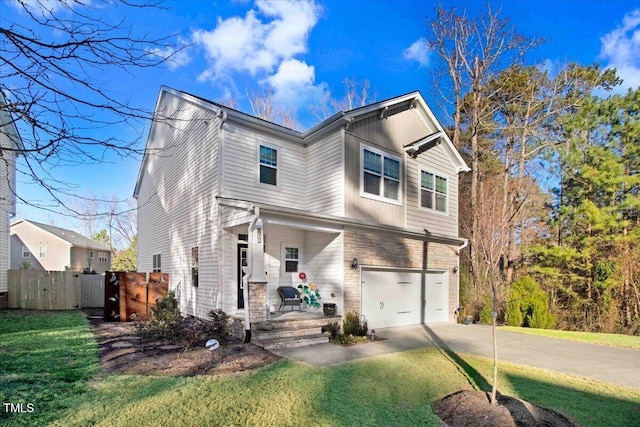 traditional-style house featuring driveway, an attached garage, fence, and a front lawn