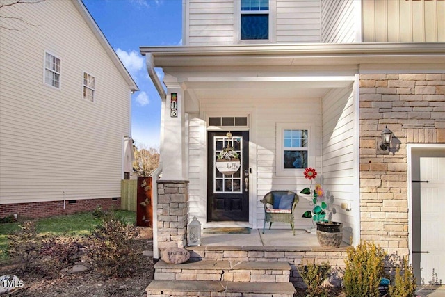 property entrance featuring covered porch and brick siding