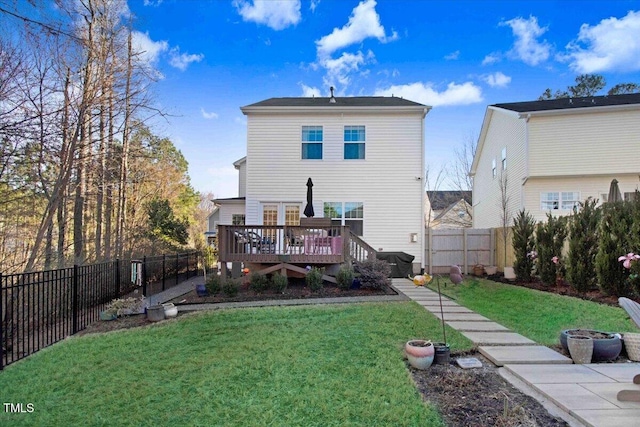 back of house featuring a fenced backyard, a yard, and a wooden deck