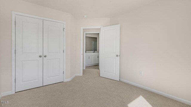 517 Old Battle Bridge Rd, Wendell, NC 27591 - unfurnished bedroom featuring baseboards, a closet, and light carpet