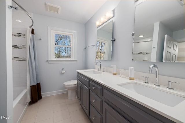 full bath with toilet, shower / tub combo, visible vents, and a sink