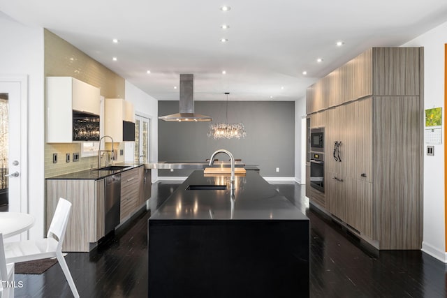 kitchen featuring a center island with sink, dark countertops, modern cabinets, island exhaust hood, and a sink