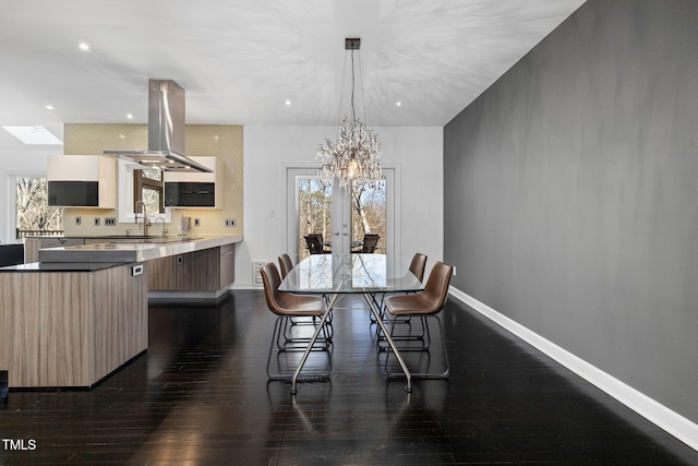 dining space with recessed lighting, baseboards, french doors, dark wood finished floors, and an inviting chandelier