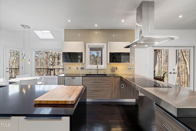 kitchen with decorative backsplash, a sink, island range hood, dishwasher, and black electric cooktop