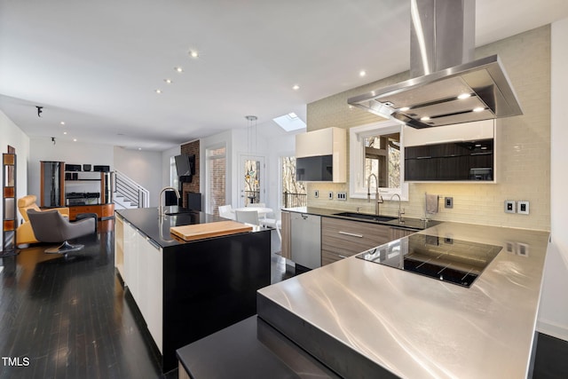 kitchen with dishwasher, an island with sink, modern cabinets, island exhaust hood, and a sink