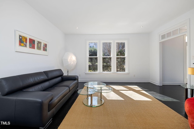 living room featuring dark wood-style flooring, recessed lighting, and baseboards