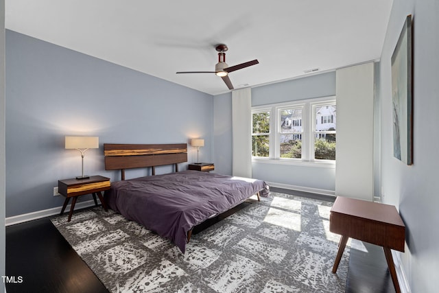 bedroom featuring ceiling fan, baseboards, and dark wood-type flooring