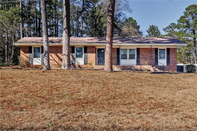 ranch-style home with a front lawn and brick siding