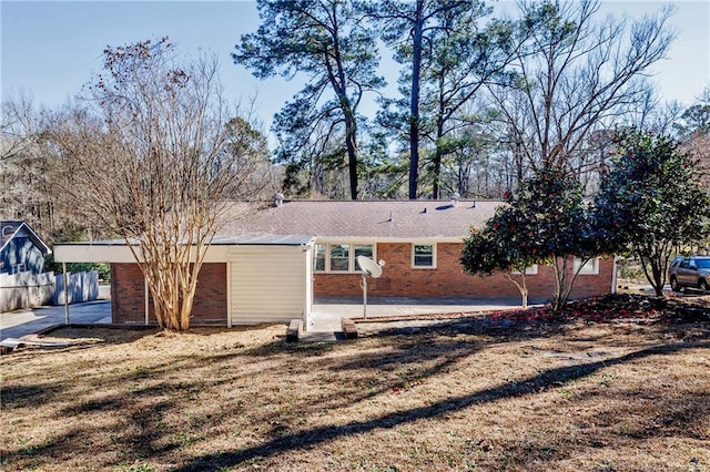 single story home featuring a patio area, brick siding, and a front lawn