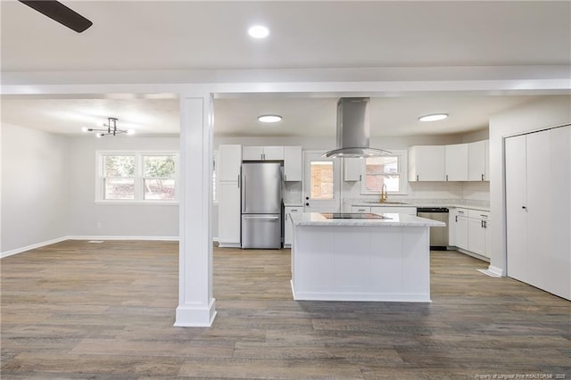 1612 Rogers Dr, Fayetteville, NC 28303 - kitchen featuring appliances with stainless steel finishes, island range hood, a sink, a center island, and light countertops