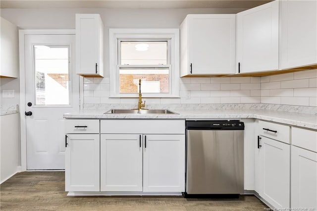 1612 Rogers Dr, Fayetteville, NC 28303 - kitchen with stainless steel dishwasher, a sink, plenty of natural light, and white cabinetry