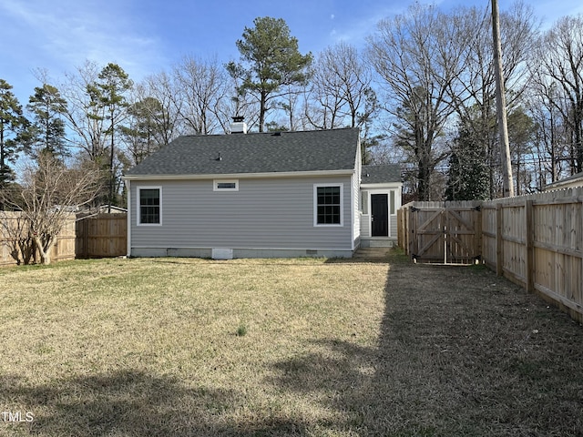 back of house featuring a fenced backyard, a shingled roof, a lawn, crawl space, and a gate