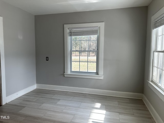 unfurnished room with baseboards