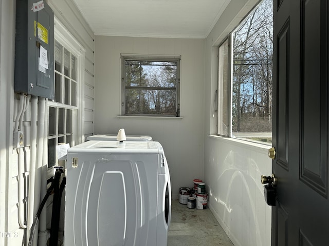 laundry area featuring laundry area, electric panel, separate washer and dryer, and crown molding