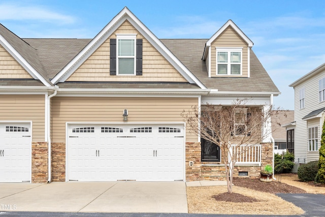 view of front of home featuring stone siding and driveway