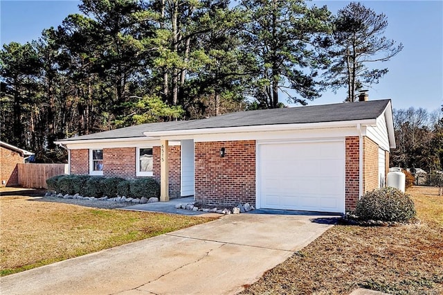 ranch-style house with brick siding, concrete driveway, an attached garage, fence, and a front yard