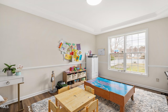 recreation room with baseboards and wood finished floors