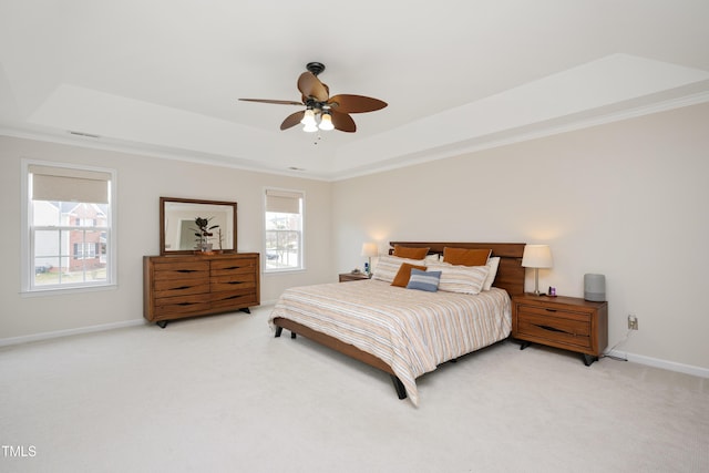 bedroom with visible vents, a raised ceiling, a ceiling fan, baseboards, and light colored carpet