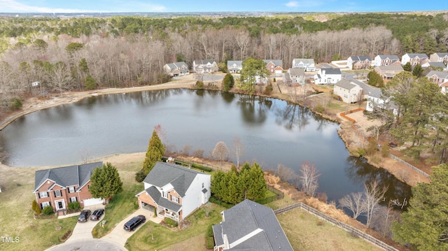 aerial view with a forest view, a residential view, and a water view