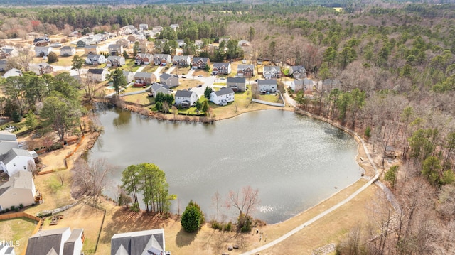 aerial view featuring a residential view, a view of trees, and a water view