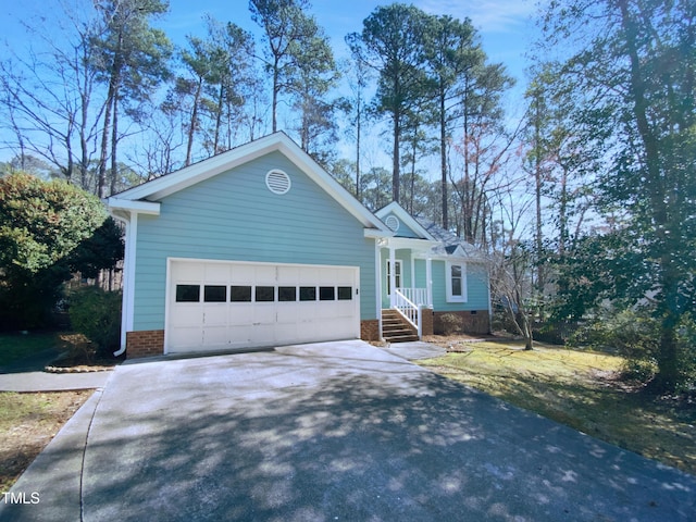 ranch-style home featuring a garage and driveway