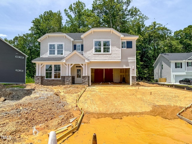 1905 Old Bramble Ln Unit 4, Fuquay Varina, NC 27526 - craftsman inspired home with stone siding, an attached garage, driveway, and view of scattered trees