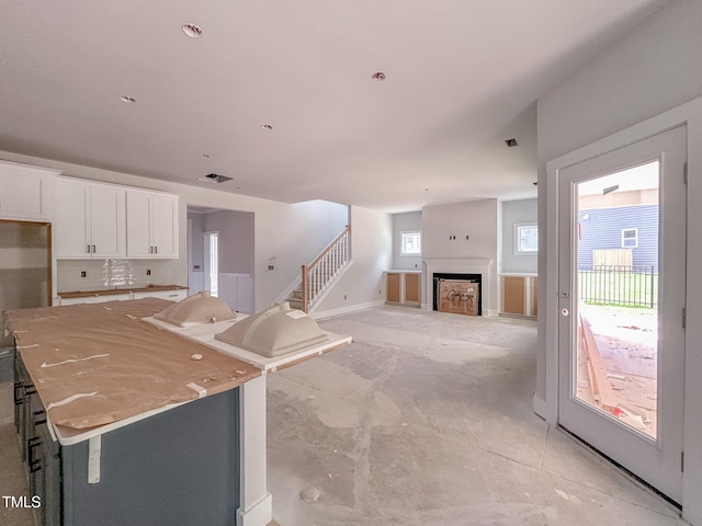 1905 Old Bramble Ln Unit 4, Fuquay Varina, NC 27526 - kitchen featuring white cabinets, a fireplace, and open floor plan