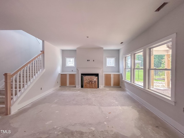 1905 Old Bramble Ln Unit 4, Fuquay Varina, NC 27526 - unfurnished living room featuring unfinished concrete flooring, stairway, and a fireplace
