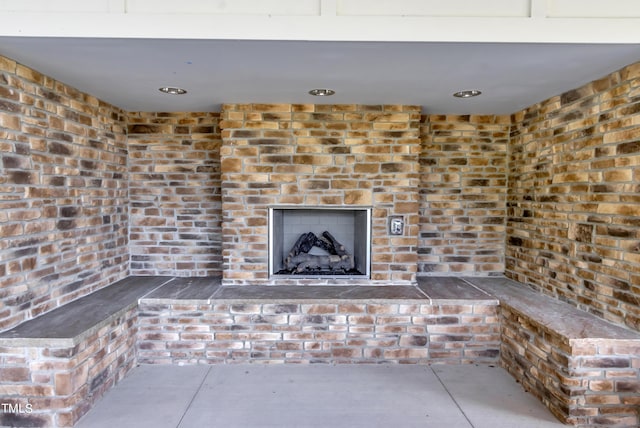 interior space with finished concrete flooring and a brick fireplace