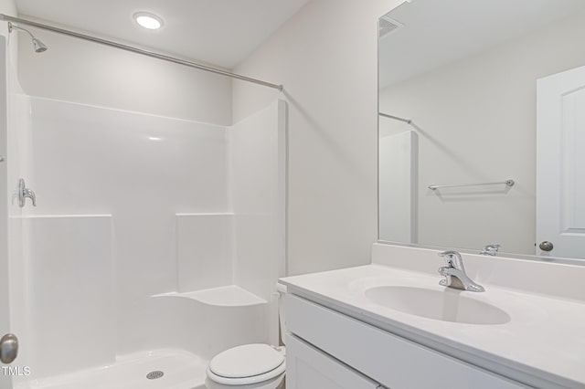 bathroom with toilet, a shower stall, visible vents, and vanity