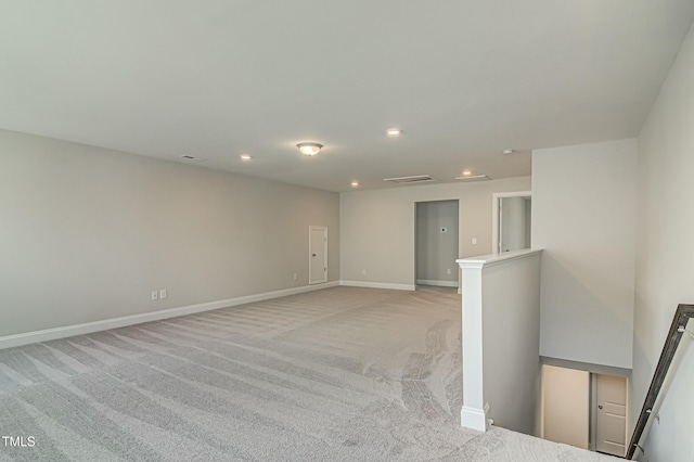 spare room featuring recessed lighting, visible vents, light carpet, and baseboards