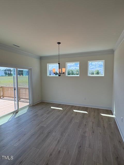 190 Sage Ln Unit 015, Four Oaks, NC 27524 - unfurnished dining area featuring ornamental molding, a chandelier, dark wood-style floors, and baseboards