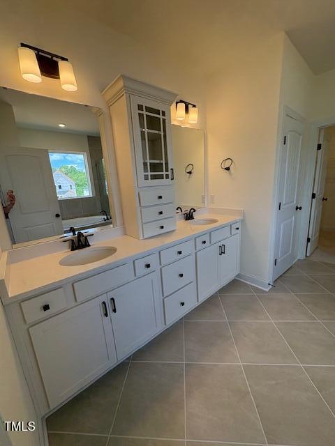 190 Sage Ln Unit 015, Four Oaks, NC 27524 - bathroom featuring tile patterned flooring, double vanity, and baseboards