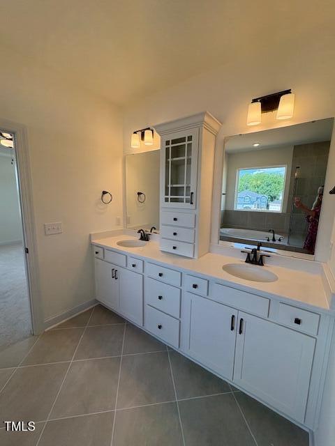 190 Sage Ln Unit 015, Four Oaks, NC 27524 - full bathroom with tile patterned floors, double vanity, a bath, and a tile shower