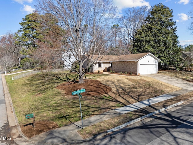 ranch-style house featuring a front lawn, brick siding, driveway, and an attached garage