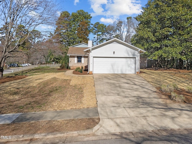 single story home with stucco siding, fence, a garage, driveway, and a front lawn