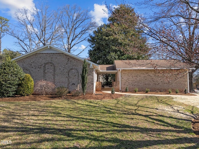 ranch-style home with a front lawn and brick siding