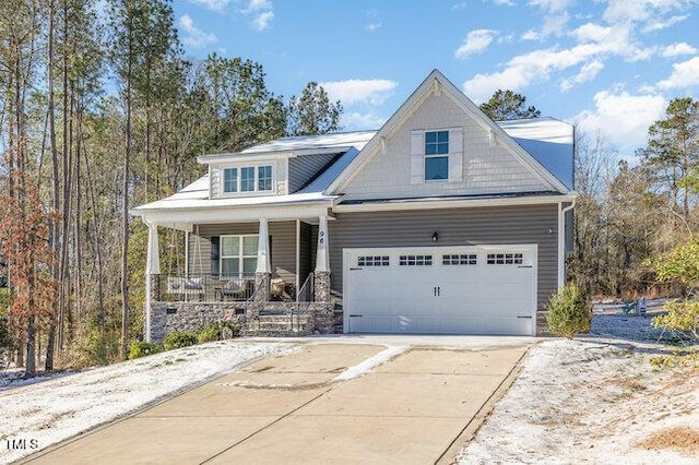 craftsman-style house featuring a porch and concrete driveway