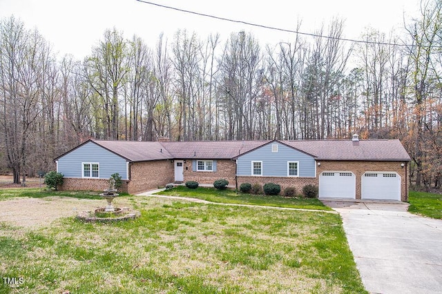 ranch-style home with brick siding, driveway, a chimney, and a front lawn