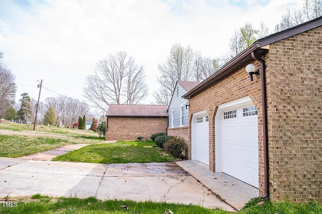 view of side of home featuring a yard and brick siding